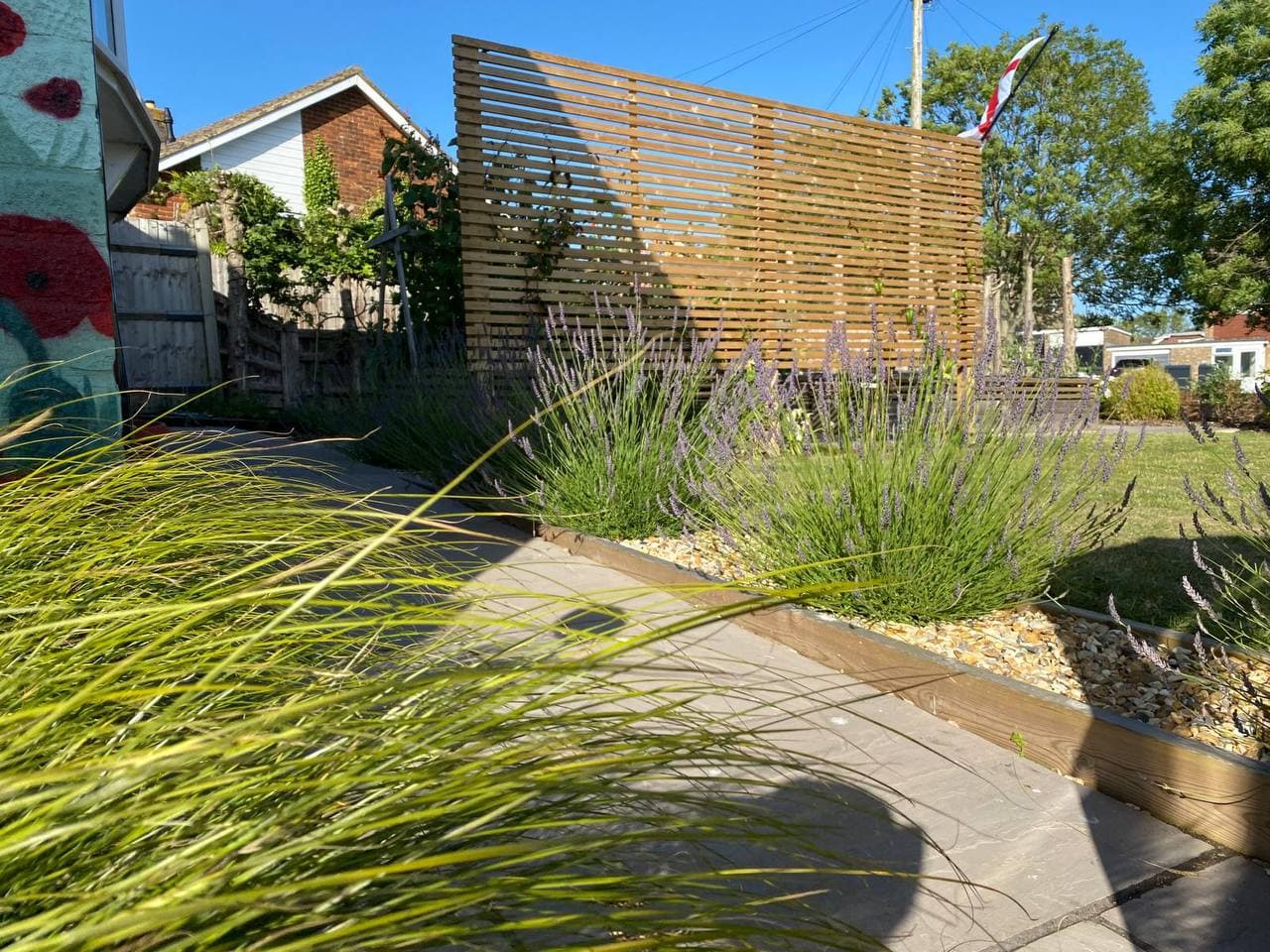 Garden design with wooden pergola and ornamental grasses